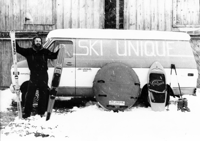 Gary Breisch, Owner and founder of Ski-Unique water, snow, and skate shop. Here he is in the snow with equipment in front of the original barnhouse.